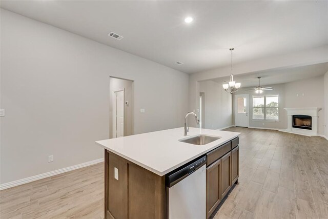 15044 Ted Trl, Aledo, TX 76008 - kitchen with a sink, appliances with stainless steel finishes, light wood finished floors, a kitchen island with sink, and light countertops