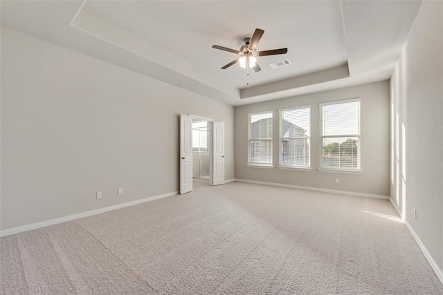 15044 Ted Trl, Aledo, TX 76008 - unfurnished room featuring a tray ceiling, a ceiling fan, baseboards, and light colored carpet
