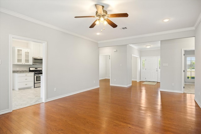 unfurnished living room featuring light wood-style floors, ornamental molding, baseboards, and ceiling fan