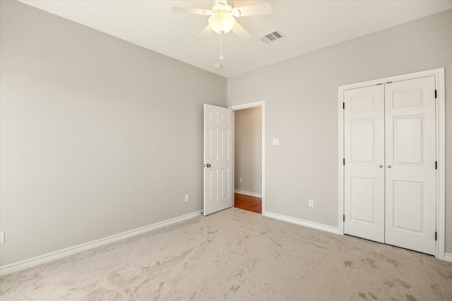 unfurnished bedroom featuring a closet, visible vents, carpet flooring, and baseboards