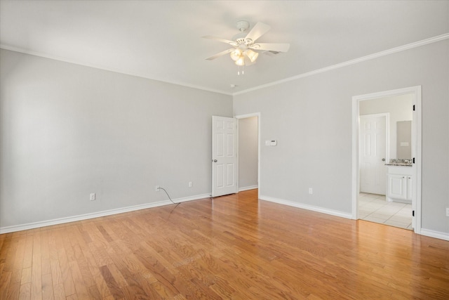 empty room with ceiling fan, baseboards, ornamental molding, and light wood-type flooring