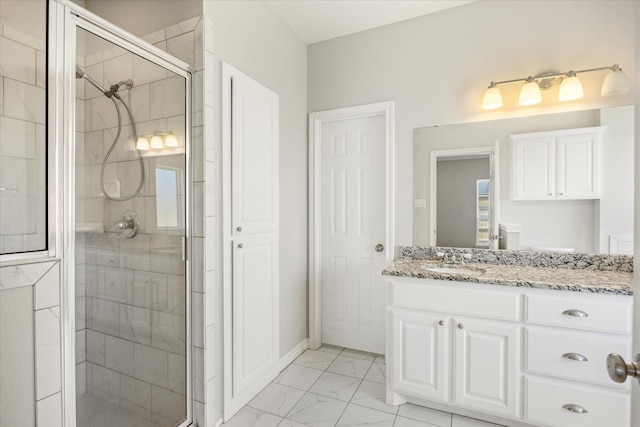 bathroom featuring a shower stall, marble finish floor, and vanity