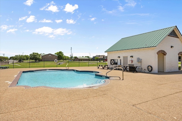 view of swimming pool with fence, a fenced in pool, and a patio