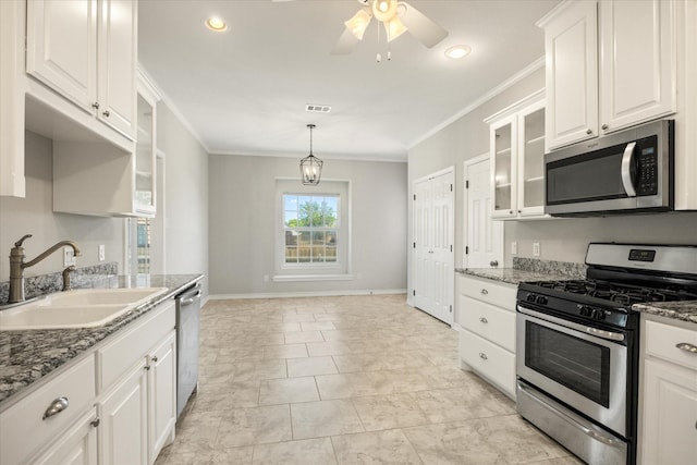 kitchen featuring white cabinets, a sink, visible vents, crown molding, and appliances with stainless steel finishes