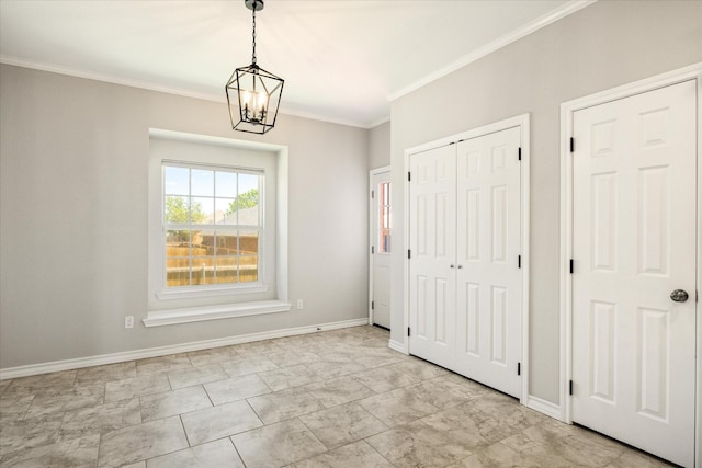 unfurnished bedroom with marble finish floor, an inviting chandelier, ornamental molding, a closet, and baseboards