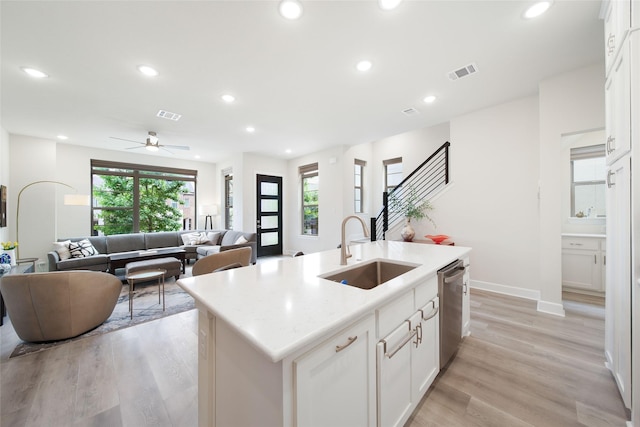 7112 Amber Grove Ct, Dallas, TX 75231 - kitchen featuring a sink, visible vents, light wood-style flooring, open floor plan, and stainless steel dishwasher