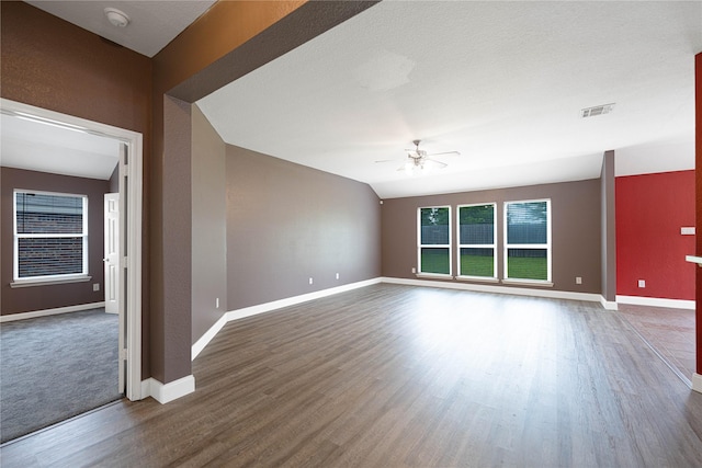 unfurnished living room featuring visible vents, baseboards, wood finished floors, and ceiling fan