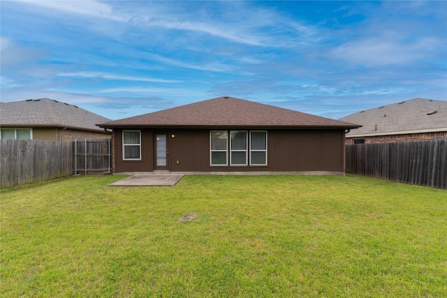 back of property featuring a patio area, a fenced backyard, and a yard