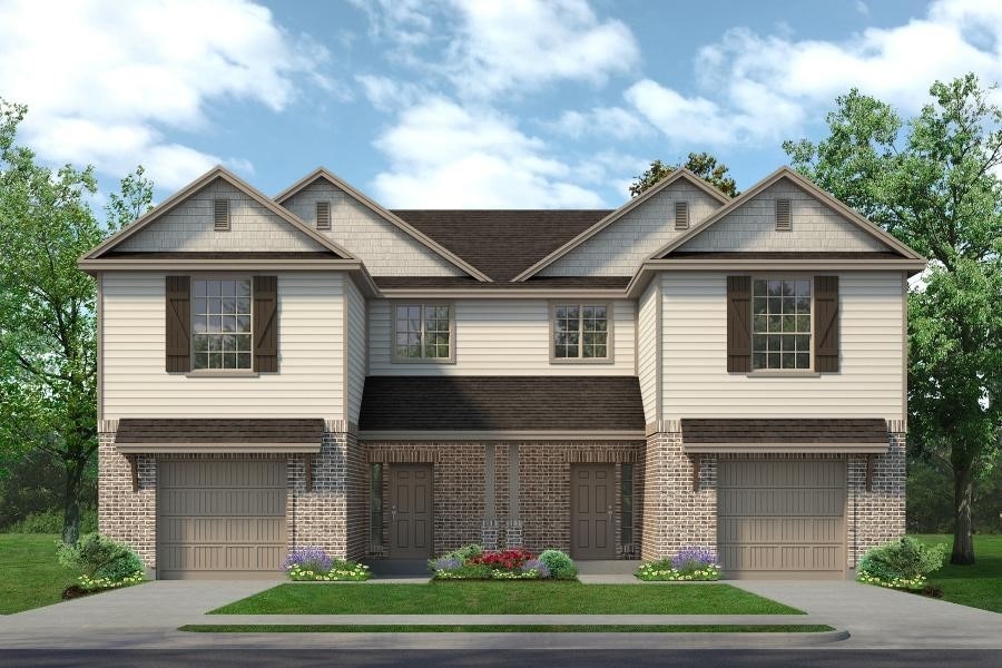 craftsman-style home with brick siding, an attached garage, a shingled roof, and driveway