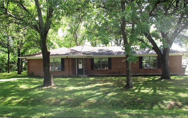 single story home with brick siding and a front yard