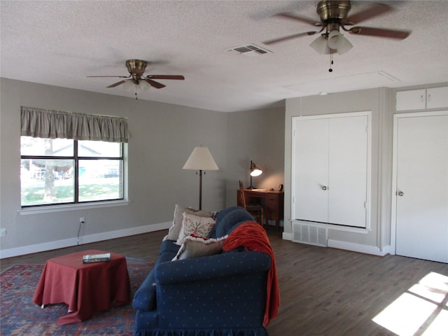 sitting room with baseboards, a ceiling fan, wood finished floors, and visible vents