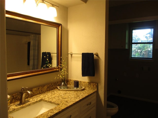 bathroom featuring a bath, toilet, vanity, and curtained shower