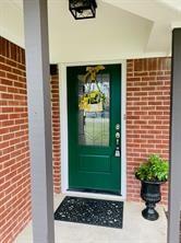 doorway to property with brick siding