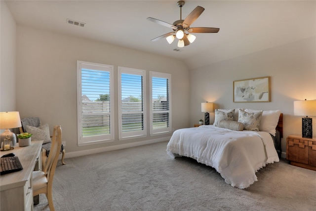carpeted bedroom featuring a ceiling fan, visible vents, lofted ceiling, and baseboards