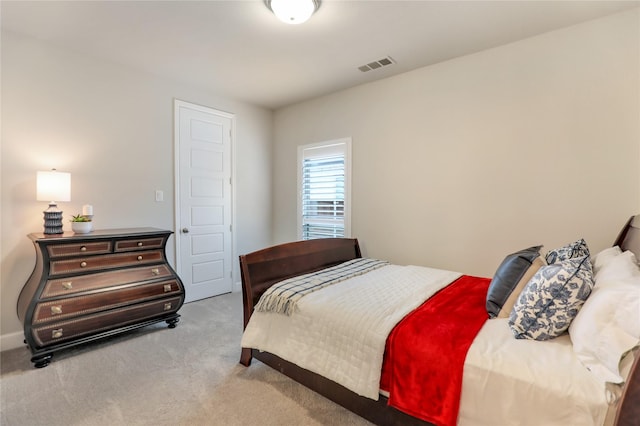 bedroom with visible vents, carpet flooring, and baseboards