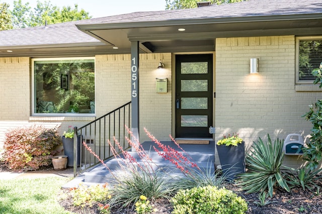 10515 Sinclair Ave, Dallas, TX 75218 - doorway to property with roof with shingles and brick siding