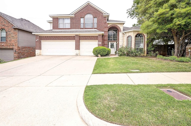 traditional-style house featuring an attached garage, brick siding, driveway, and a front lawn