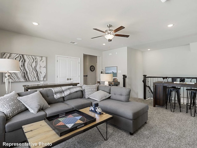 living area featuring visible vents, a ceiling fan, carpet flooring, and recessed lighting