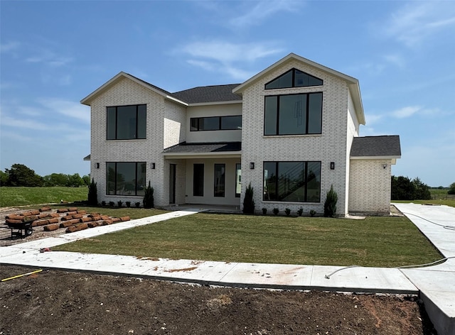 modern farmhouse with a front lawn and brick siding
