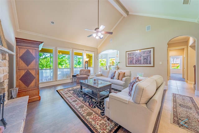 8650 Toler Pt, Larue, TX 75770 - living area with high vaulted ceiling, ceiling fan, arched walkways, light wood finished floors, and beam ceiling