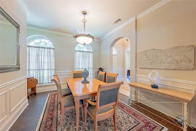 8650 Toler Pt, Larue, TX 75770 - dining space with dark wood-style floors, visible vents, arched walkways, a decorative wall, and crown molding