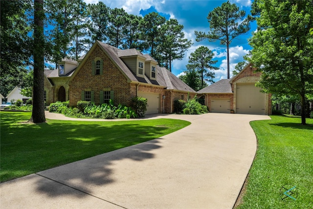 8650 Toler Pt, Larue, TX 75770 - view of front of home with a front lawn, roof with shingles, an attached garage, driveway, and brick siding