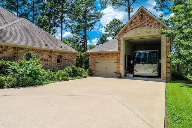 8650 Toler Pt, Larue, TX 75770 - view of front facade with brick siding, roof with shingles, and a garage