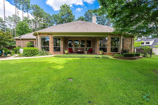 8650 Toler Pt, Larue, TX 75770 - rear view of property featuring roof with shingles, a chimney, fence, brick siding, and a lawn