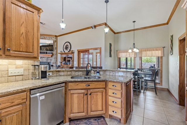 kitchen with a peninsula, stainless steel dishwasher, a healthy amount of sunlight, and a sink