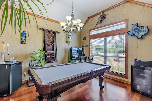 playroom with a textured wall, ornamental molding, beverage cooler, and wood finished floors