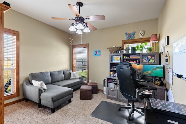 office space featuring carpet floors, a ceiling fan, and baseboards