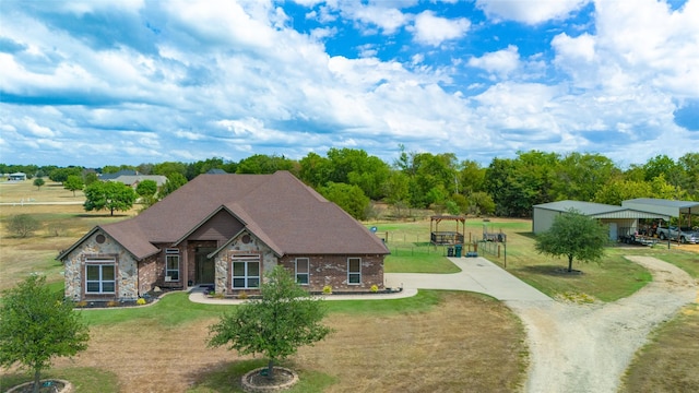 view of front of property with stone siding, a shingled roof, and a front yard