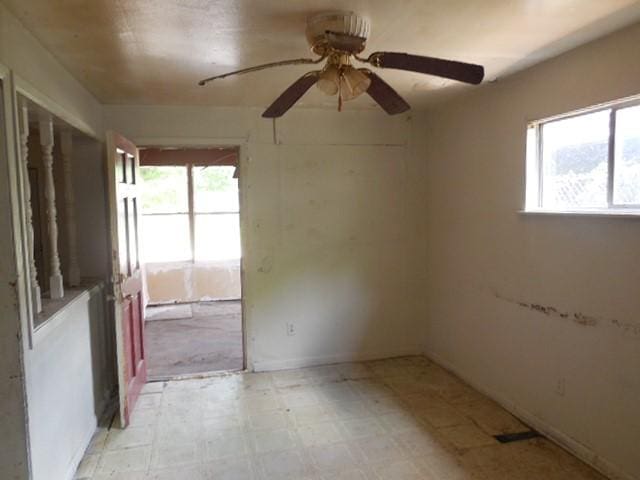 empty room featuring a ceiling fan and light floors