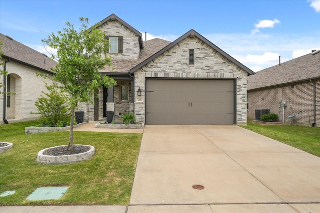 628 Claverton Ln, Forney, TX 75126 - french country home featuring concrete driveway, an attached garage, roof with shingles, and a front yard