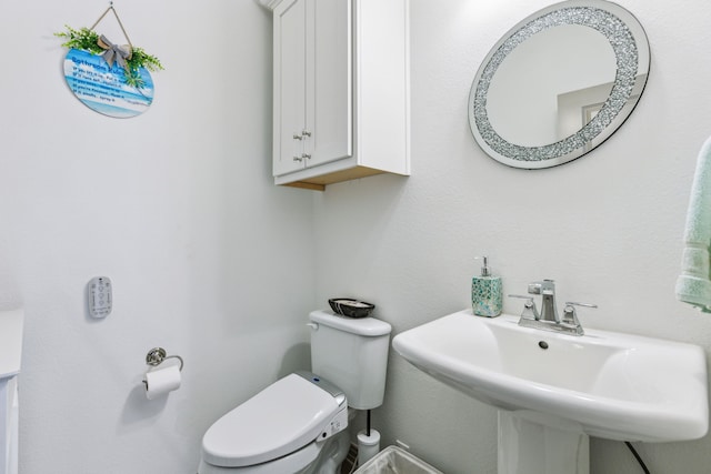 bathroom featuring toilet and a sink