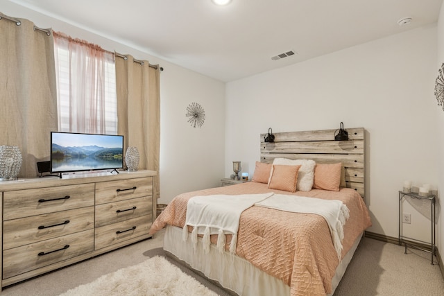 bedroom featuring light colored carpet and visible vents