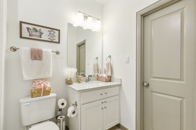 bathroom with toilet and vanity