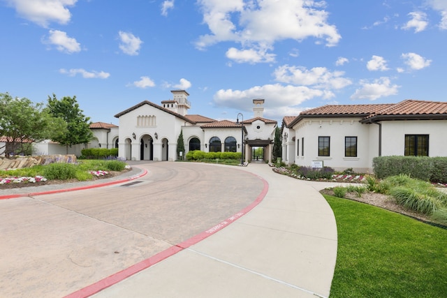 view of property featuring curved driveway