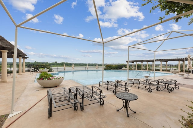 pool with a pergola and a patio area