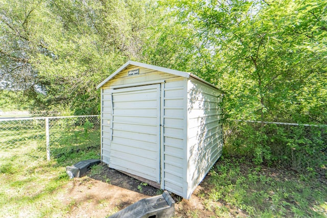 view of shed featuring fence