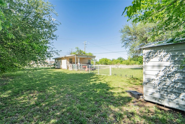 view of yard featuring an outdoor structure and fence
