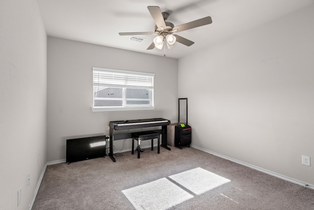 interior space featuring ceiling fan, baseboards, visible vents, and carpet