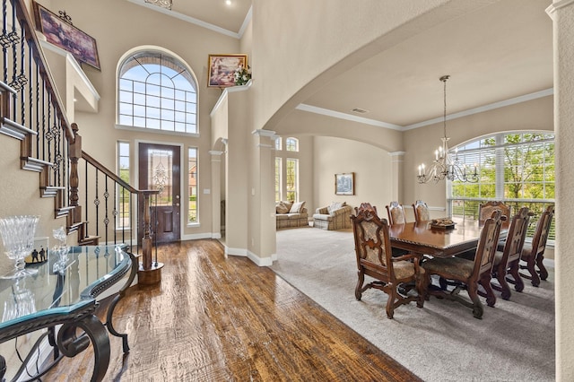 902 Alfred Dr, Wylie, TX 75098 - foyer entrance featuring arched walkways, a chandelier, ornamental molding, decorative columns, and baseboards