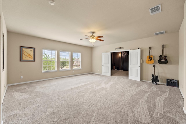 unfurnished bedroom with visible vents, baseboards, and light carpet