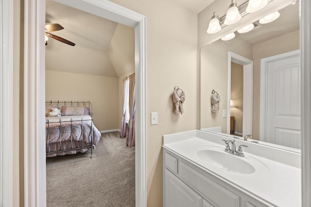 bathroom with vanity, ceiling fan, and vaulted ceiling
