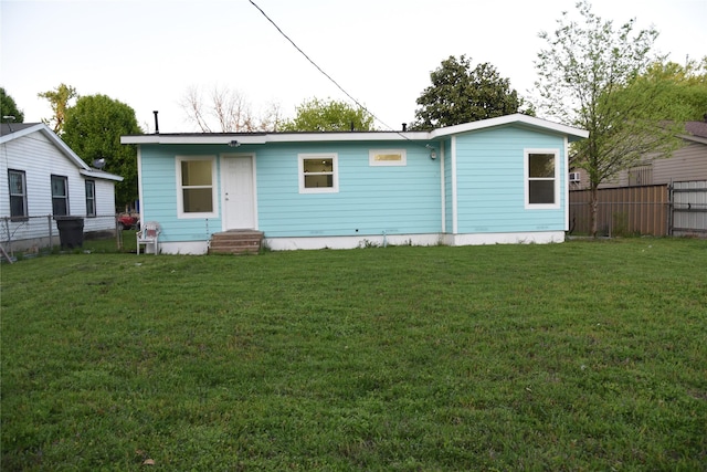 4841 Bromfield St, Dallas, TX 75216 - rear view of house with a yard, entry steps, and fence
