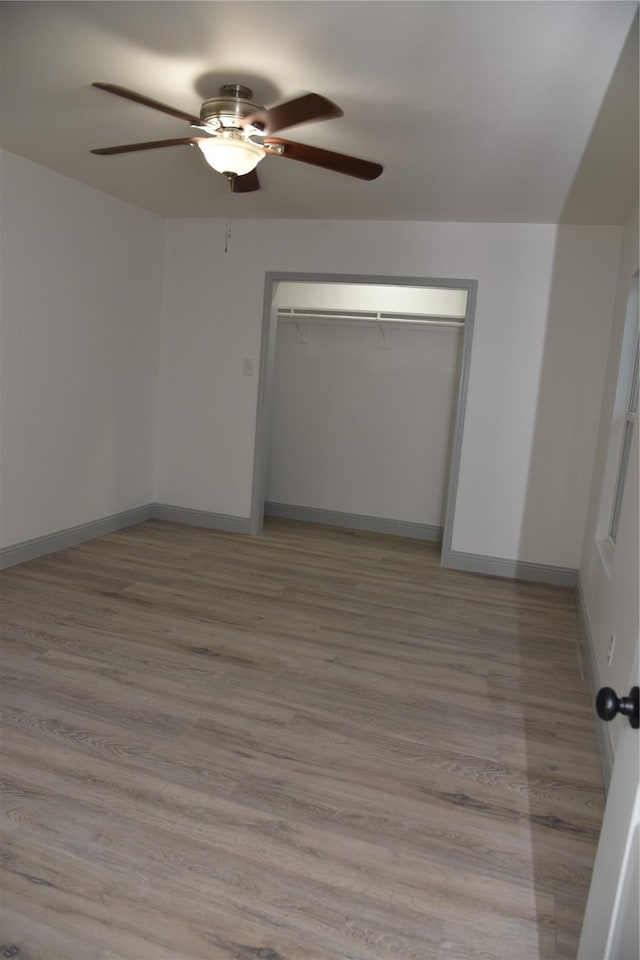 4841 Bromfield St, Dallas, TX 75216 - unfurnished bedroom with light wood finished floors, baseboards, a closet, and ceiling fan