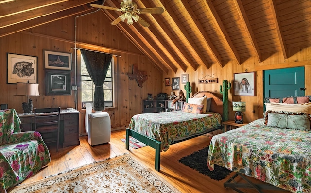 bedroom featuring light wood-style flooring, vaulted ceiling with beams, wood ceiling, and wood walls