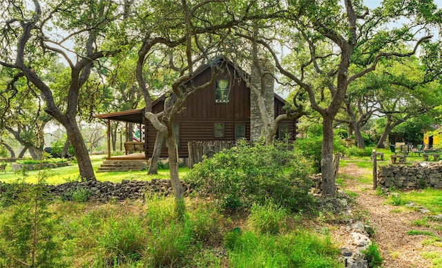 view of side of property featuring log exterior and board and batten siding