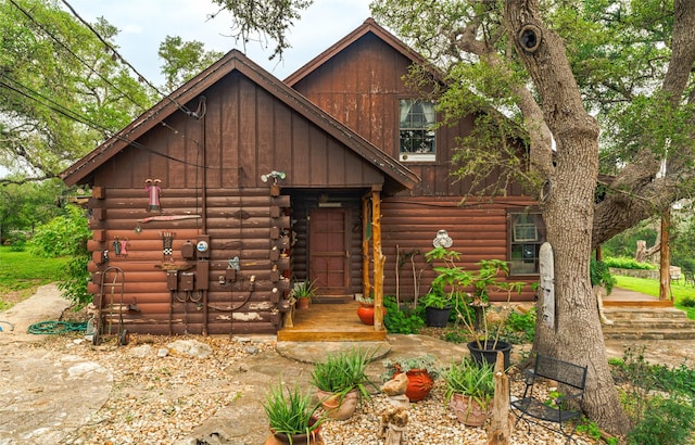 cabin with board and batten siding and log siding